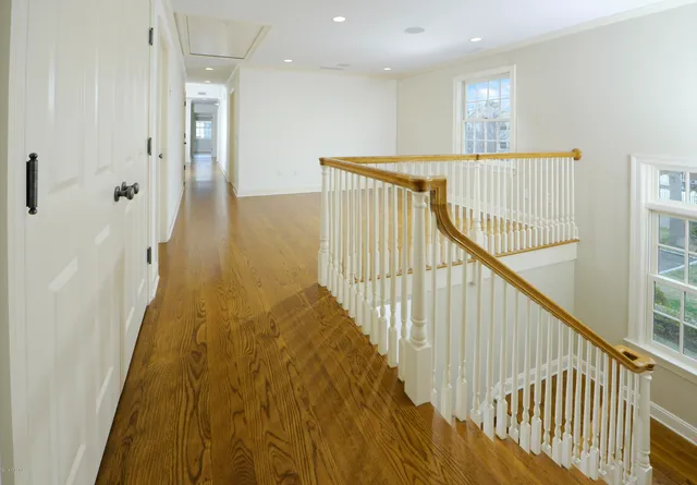 a view of hallway with wooden floor