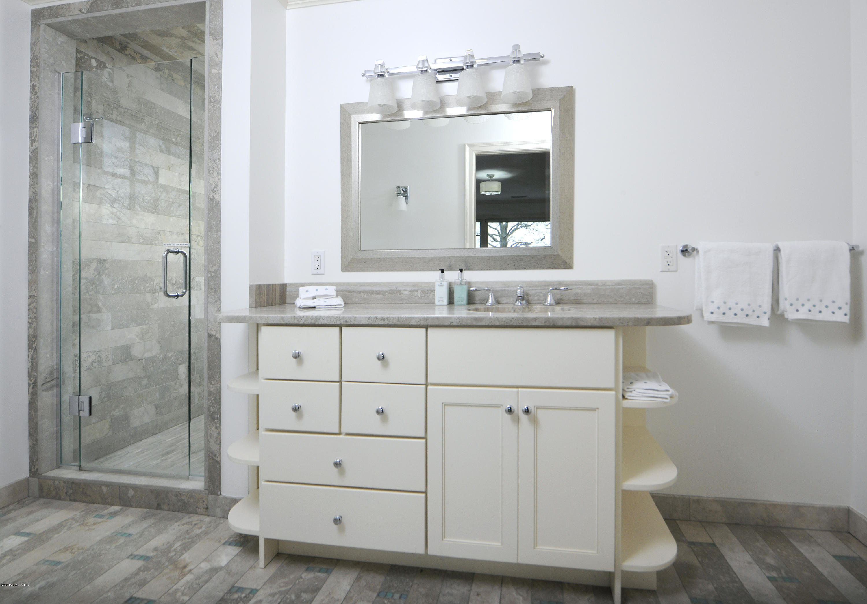 30 Rocky Point Road Old Greenwich, CT 06870 - Photo 20 of 29 a bathroom with a granite countertop sink a toilet and a mirror