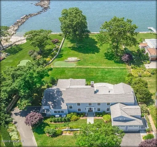 an aerial view of a house with yard swimming pool and outdoor seating