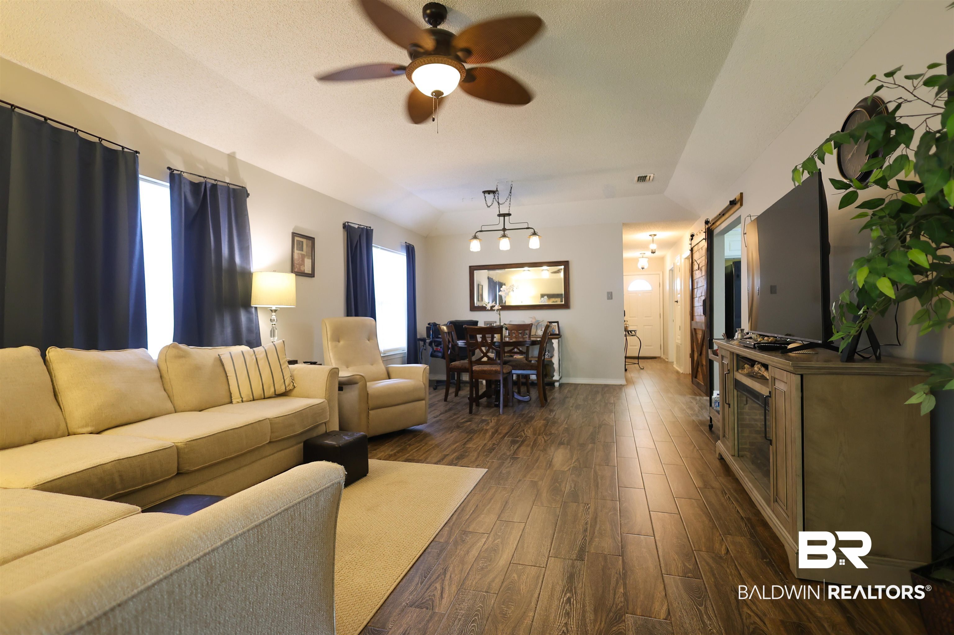 7790 Audubon Drive Foley, AL 36535 - Photo 15 of 39 Open-concept living area with wood-finish flooring extending through the space