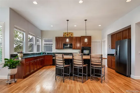 a large kitchen with a large window and stainless steel appliances