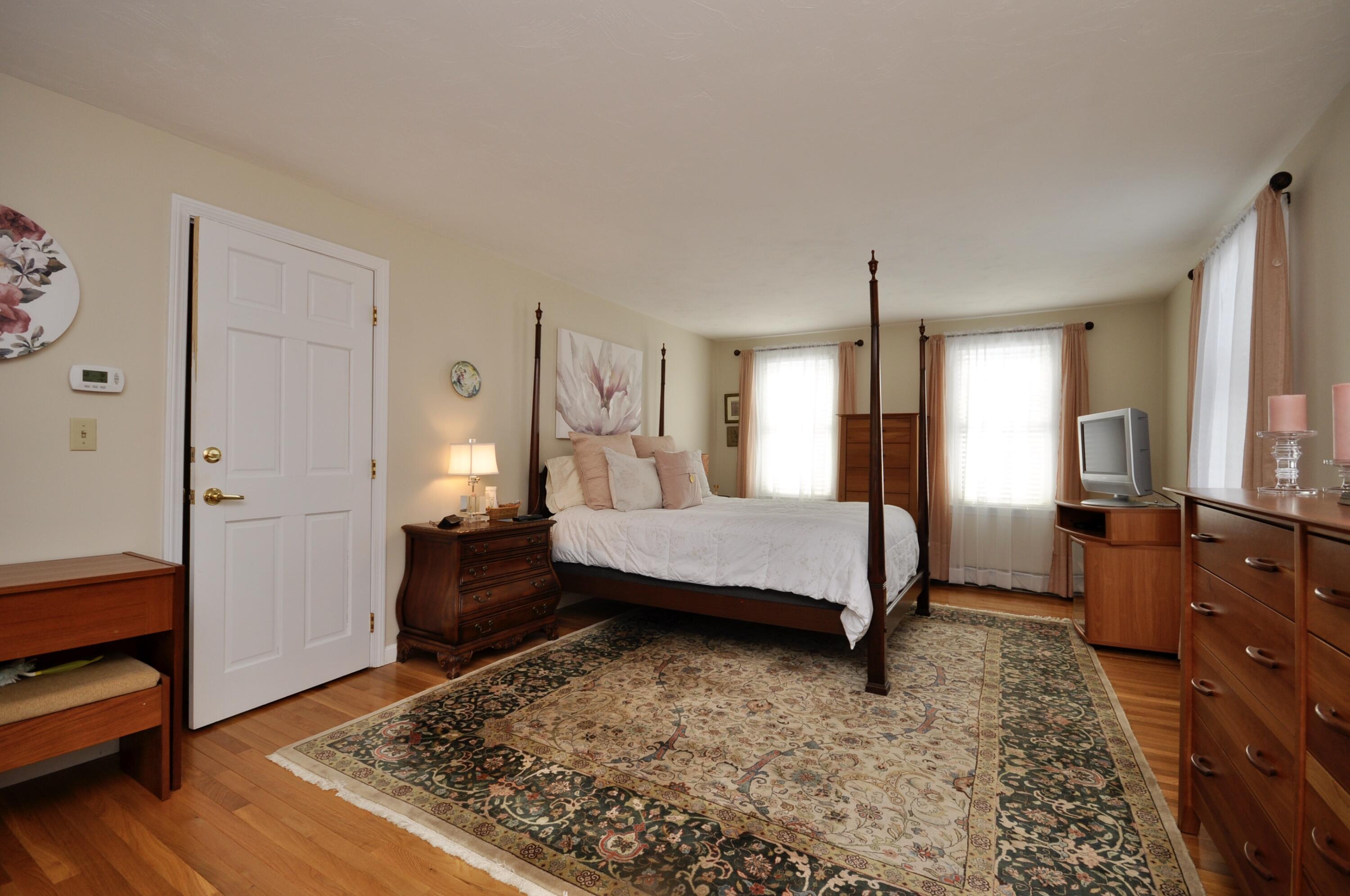 6 Cunningham Road Sagamore Beach, MA 02562 - Photo 16 of 34 a bedroom with a bed and wooden floor