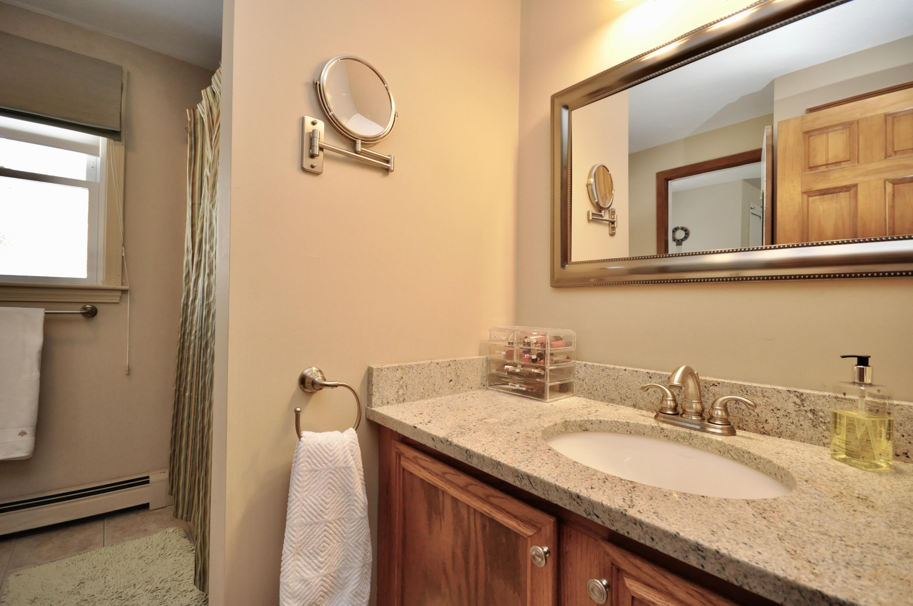 6 Cunningham Road Sagamore Beach, MA 02562 - Photo 19 of 34 a bathroom with a granite countertop sink and a mirror