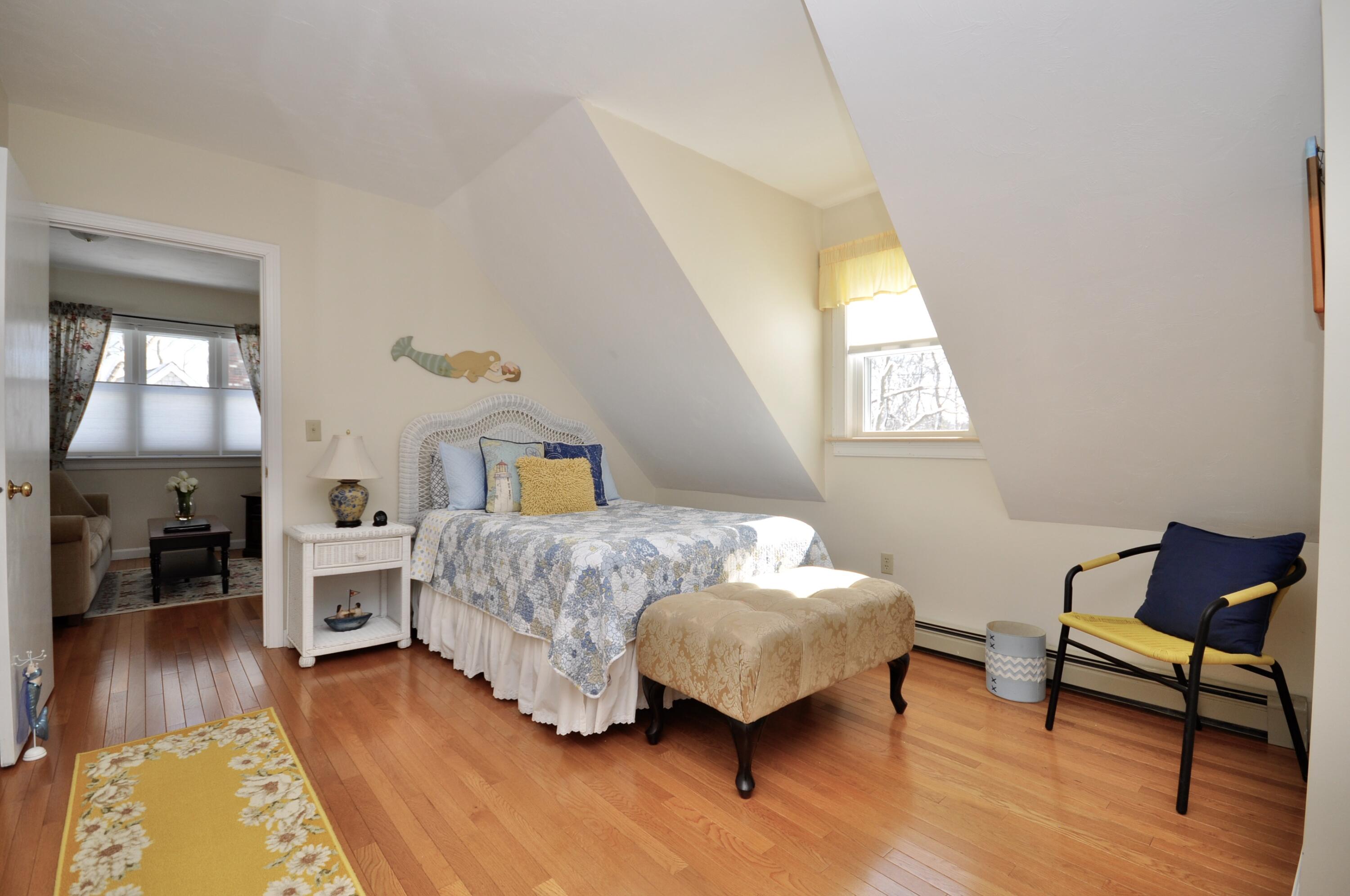 6 Cunningham Road Sagamore Beach, MA 02562 - Photo 25 of 34 a bedroom with a bed and wooden floor