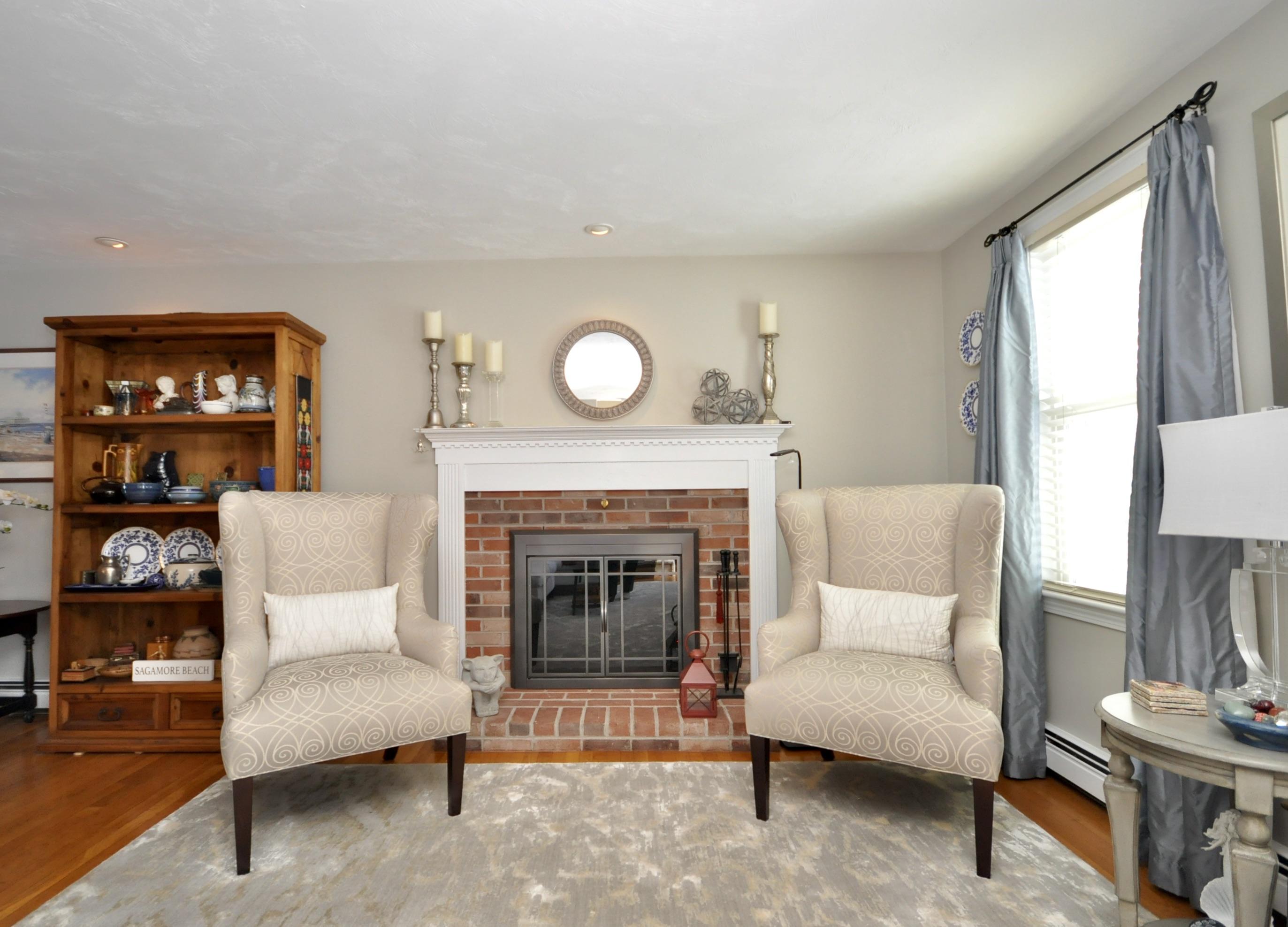 6 Cunningham Road Sagamore Beach, MA 02562 - Photo 6 of 34 a living room with furniture and a fireplace