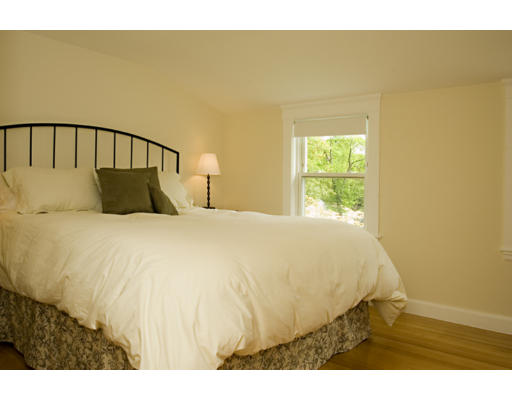 162 Overlook Road Arlington, MA 02474 - Photo 5 of 12 a bed sitting in a bedroom next to a blue wall