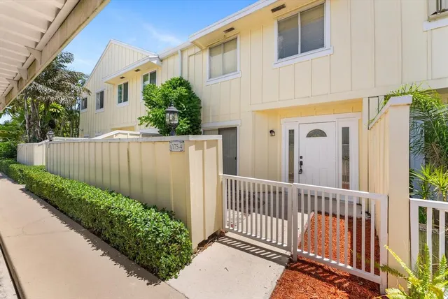 a view of a entrance to house with wooden fence