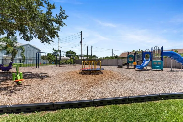 a view of a yard with plants and trees
