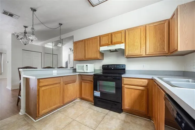 a kitchen with stainless steel appliances granite countertop a sink and cabinets