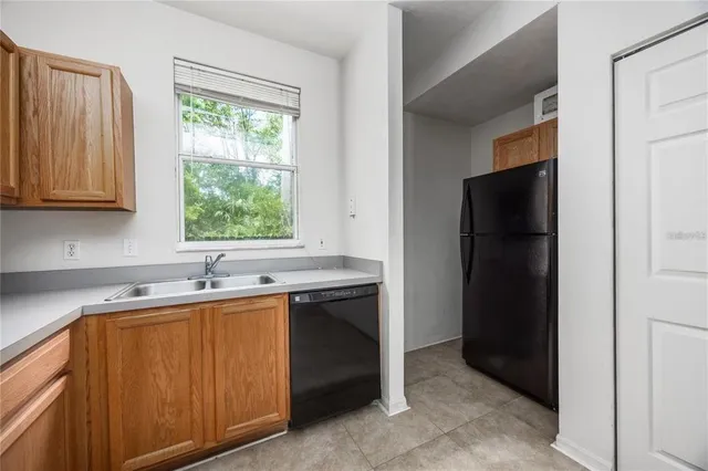 a kitchen with a refrigerator and a sink