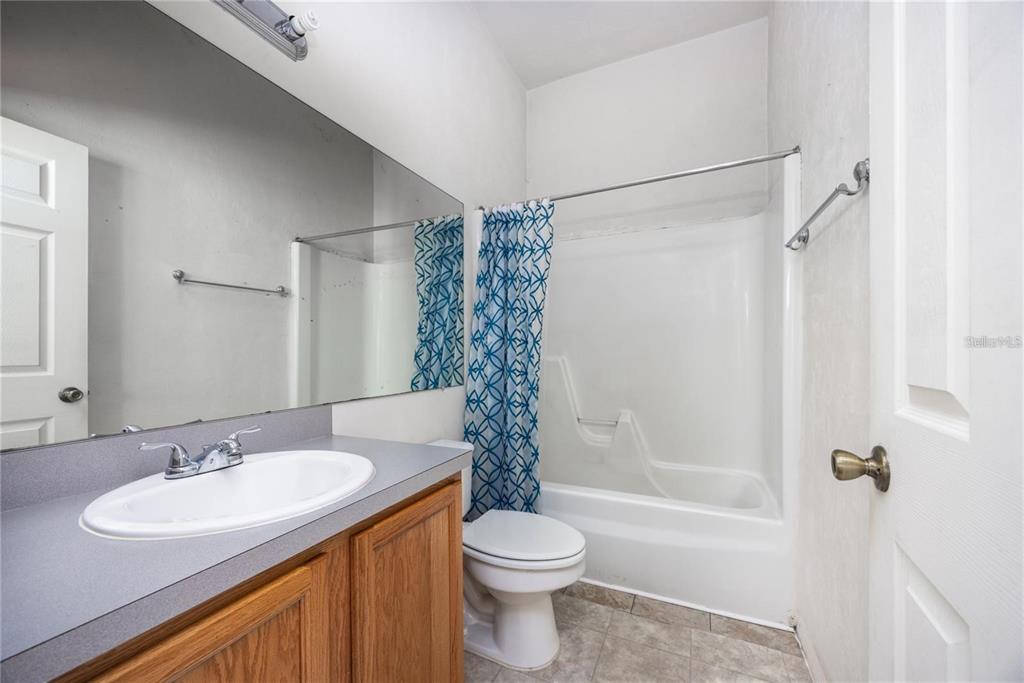 3970 Southwest 20th Avenue, Unit 909 Gainesville, FL 32607 - Photo 17 of 22 a bathroom with a sink toilet and shower