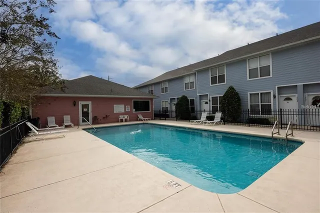 a front view of house with yard and swimming pool