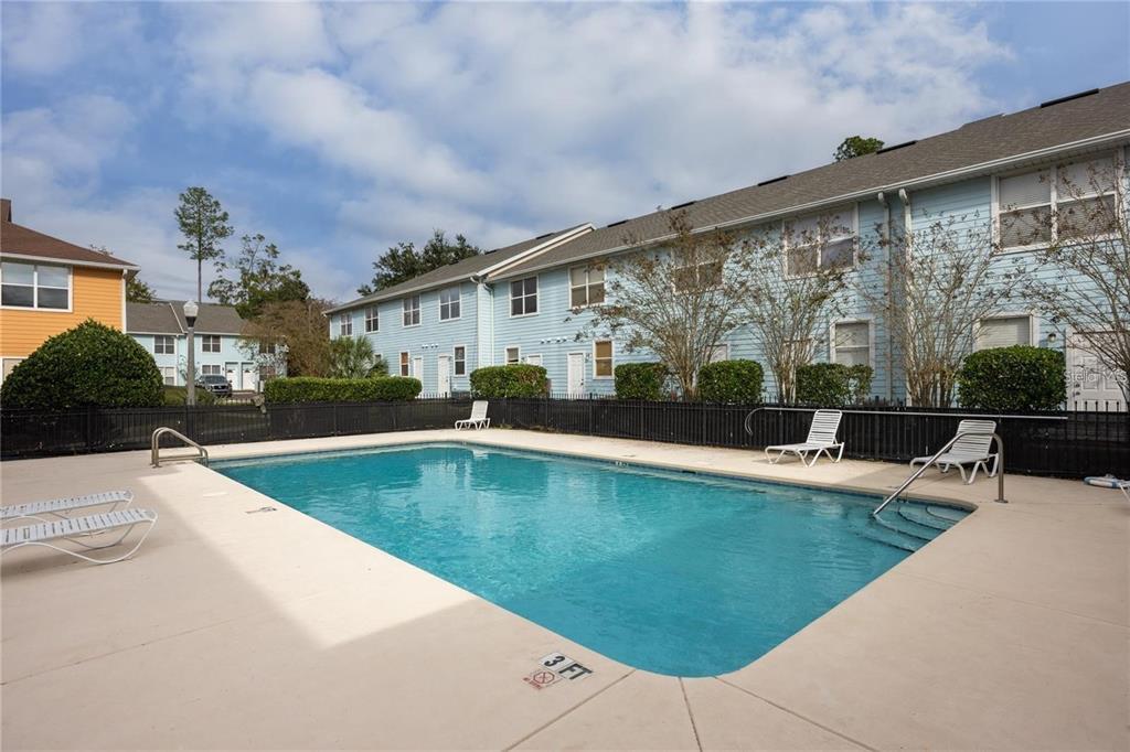 3970 Southwest 20th Avenue, Unit 909 Gainesville, FL 32607 - Photo 22 of 22 a view of swimming pool with outdoor seating and plants