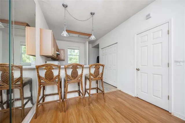 a dining room with furniture window and wooden floor