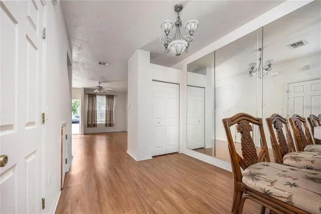 a view of a dining room with furniture wooden floor and chandelier