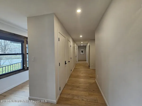 a view of a lush green forest with a house
