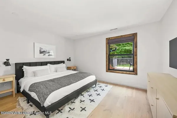 a kitchen with stainless steel appliances a table chairs and a refrigerator