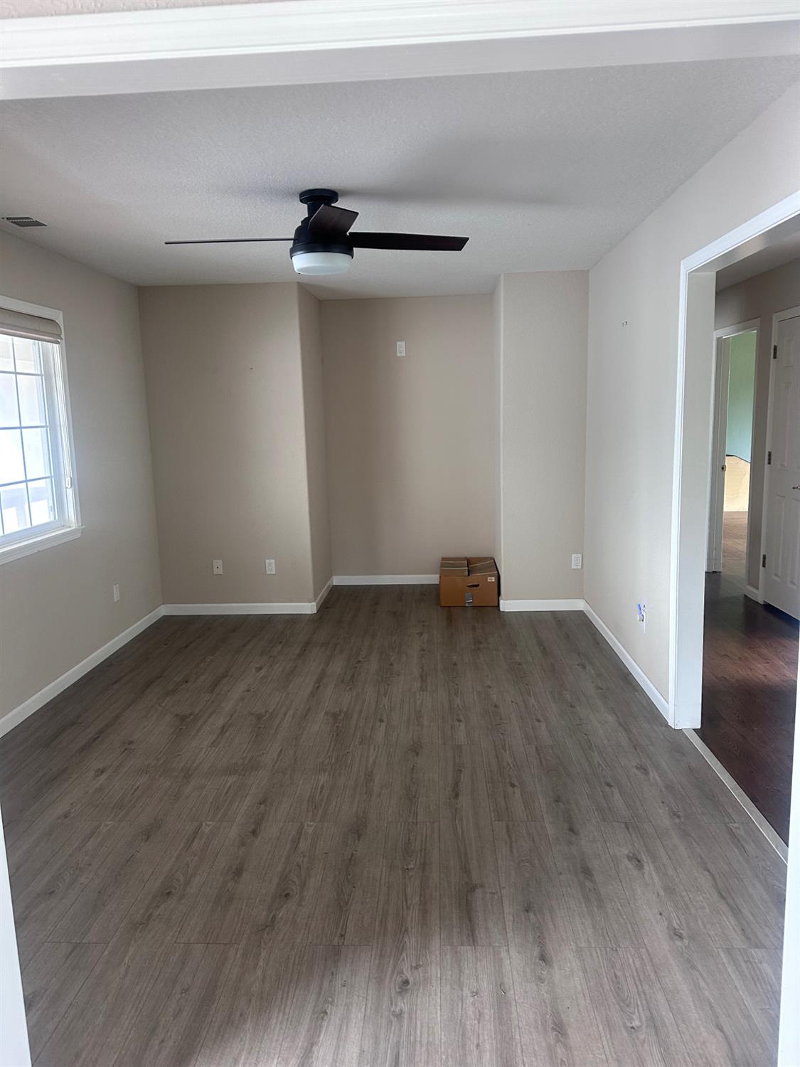 7124 Ospital Road Valley Springs, CA 95252 - Photo 25 of 37 an empty room with wooden floor and a ceiling fan