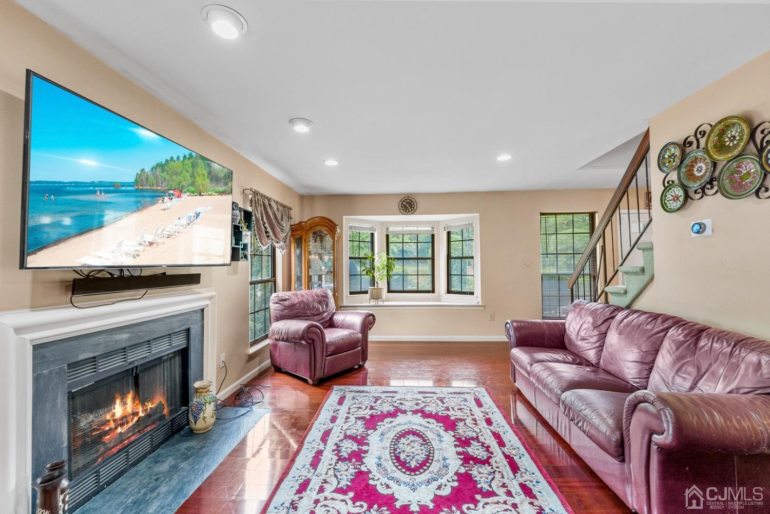 301 Maplecrest Road Edison, NJ 08820 - Photo 11 of 21 a living room with furniture and a fireplace
