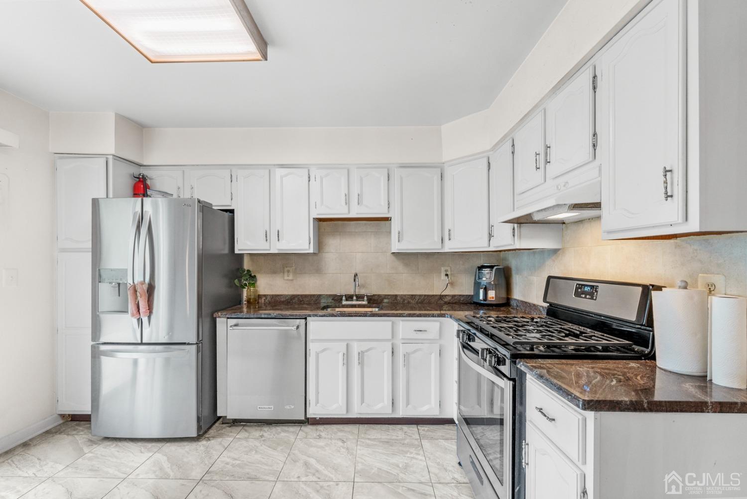 301 Maplecrest Road Edison, NJ 08820 - Photo 6 of 21 a kitchen with a white cabinets and white appliances