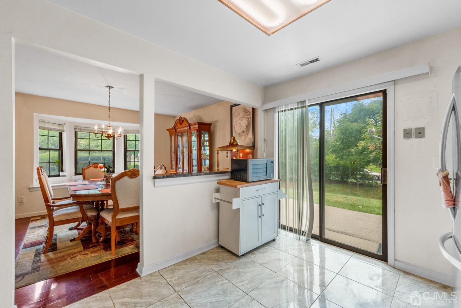 301 Maplecrest Road Edison, NJ 08820 - Photo 7 of 21 a kitchen that has a lot of furniture and a large window