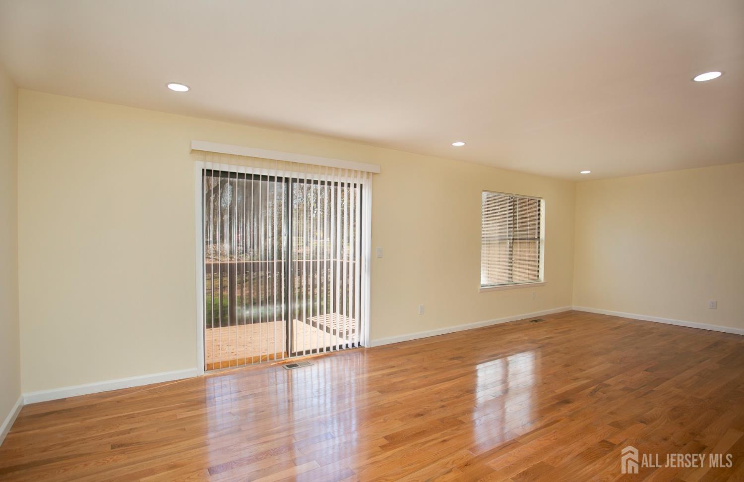 7 Cactus Court Edison, NJ 08820 - Photo 11 of 38 a view of an empty room with wooden floor and a window