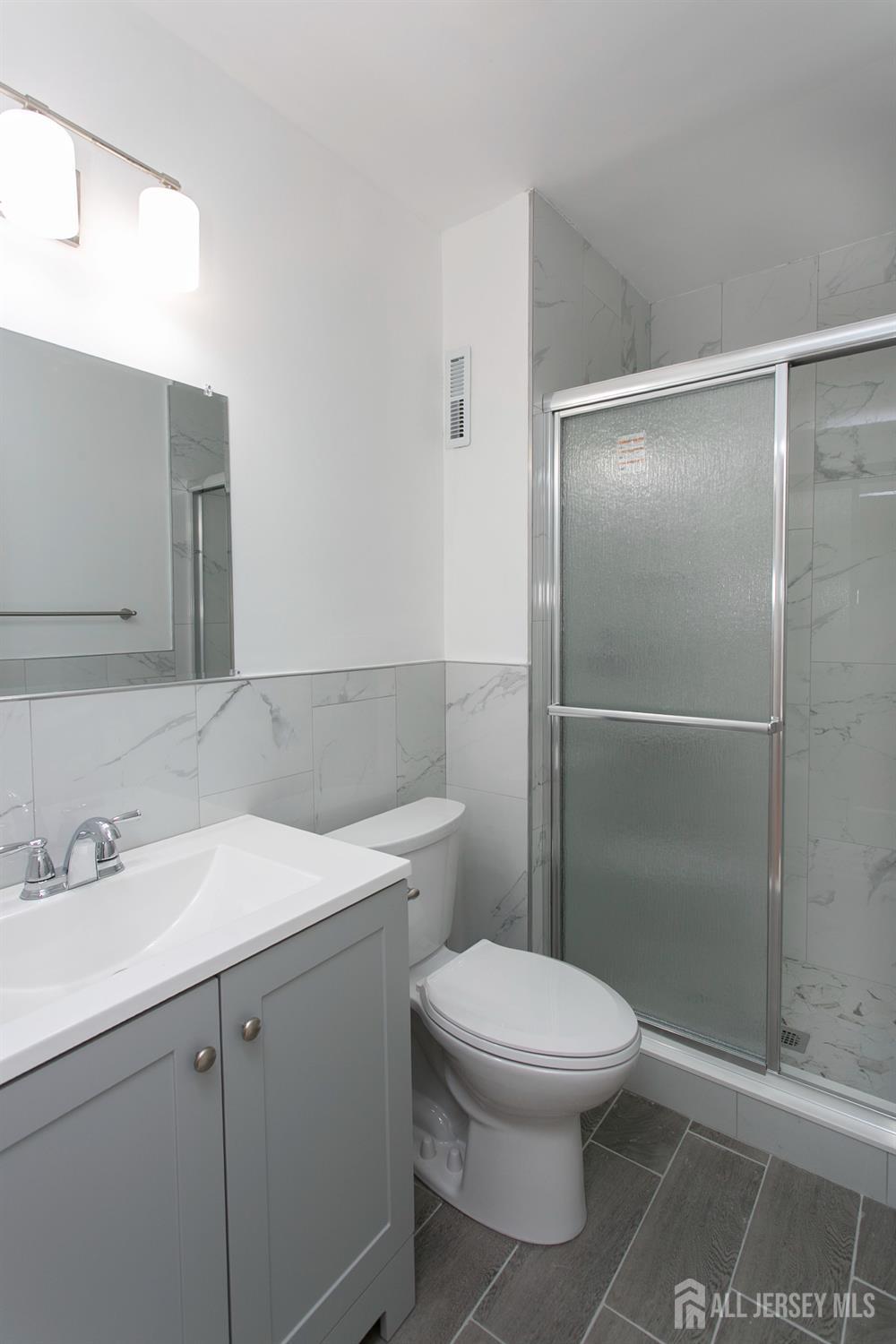 7 Cactus Court Edison, NJ 08820 - Photo 16 of 38 a bathroom with a toilet a sink and shower