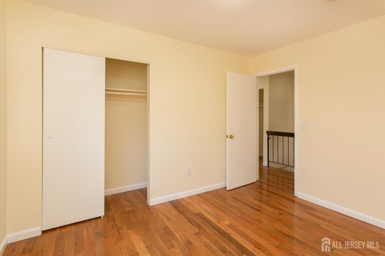 7 Cactus Court Edison, NJ 08820 - Photo 17 of 38 a view of an empty room with wooden floor and a bathroom