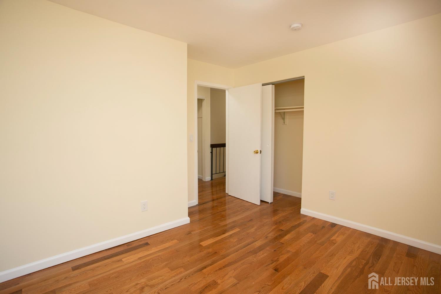 7 Cactus Court Edison, NJ 08820 - Photo 20 of 38 a view of an empty room with wooden floor