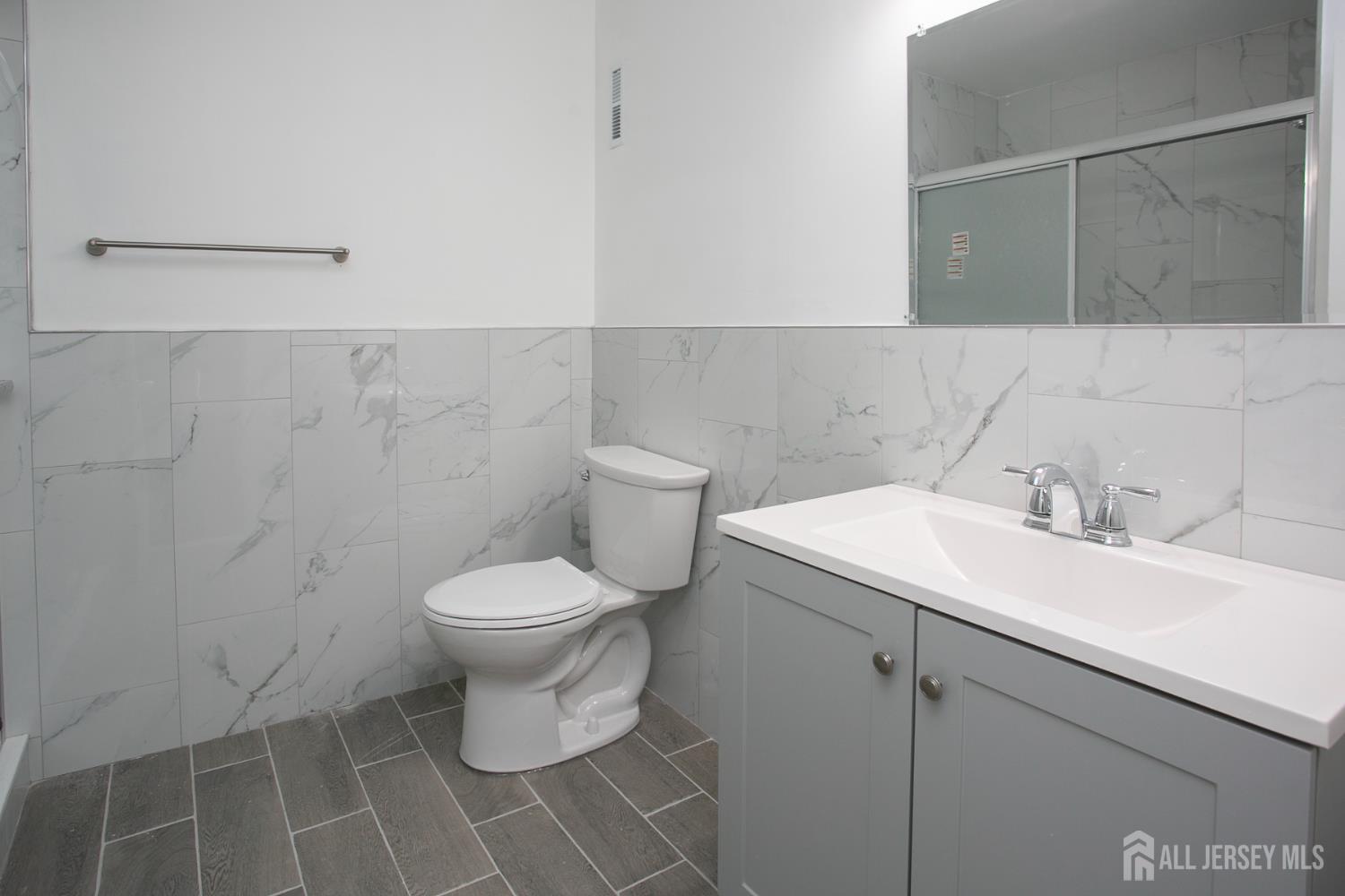 7 Cactus Court Edison, NJ 08820 - Photo 21 of 38 a bathroom with a sink and a toilet