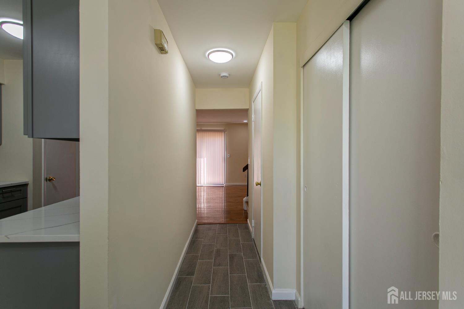 7 Cactus Court Edison, NJ 08820 - Photo 6 of 38 a view of a bathroom from a hallway