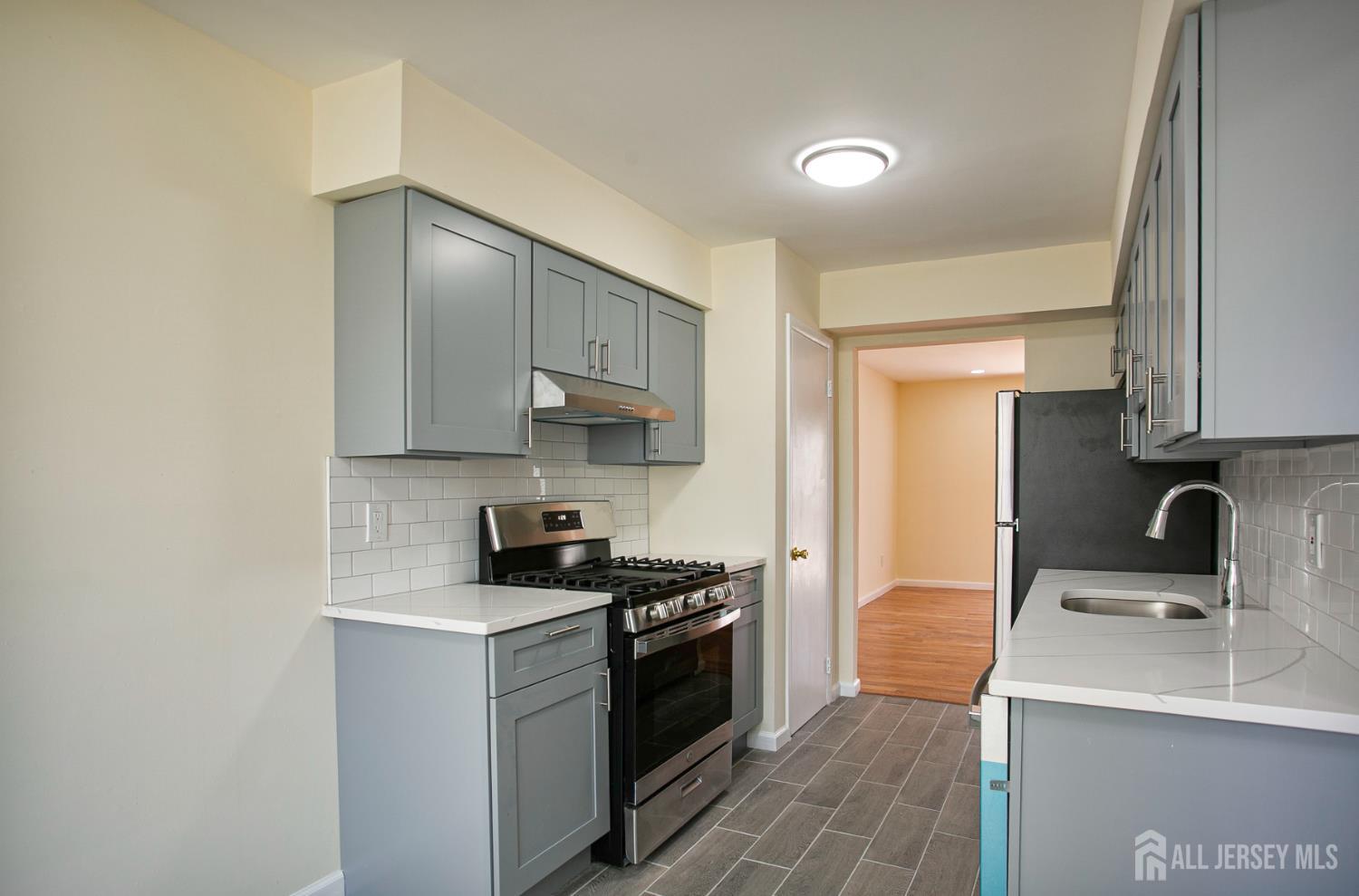 7 Cactus Court Edison, NJ 08820 - Photo 7 of 38 a kitchen with a sink cabinets and stainless steel appliances