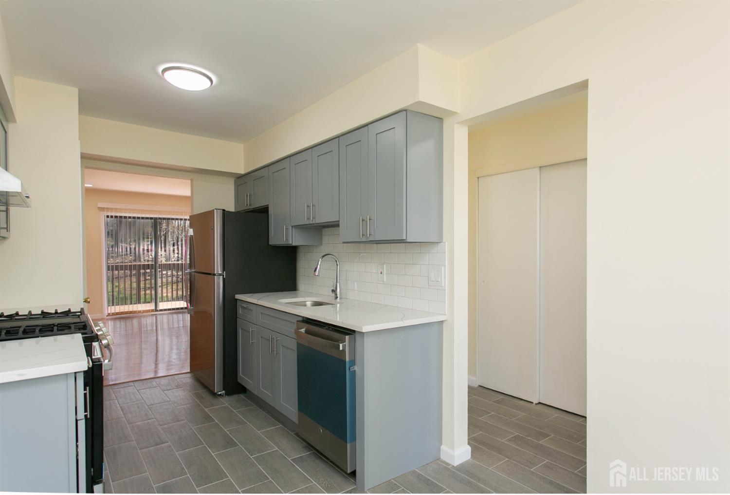 7 Cactus Court Edison, NJ 08820 - Photo 8 of 38 a kitchen with stainless steel appliances a sink stove and refrigerator