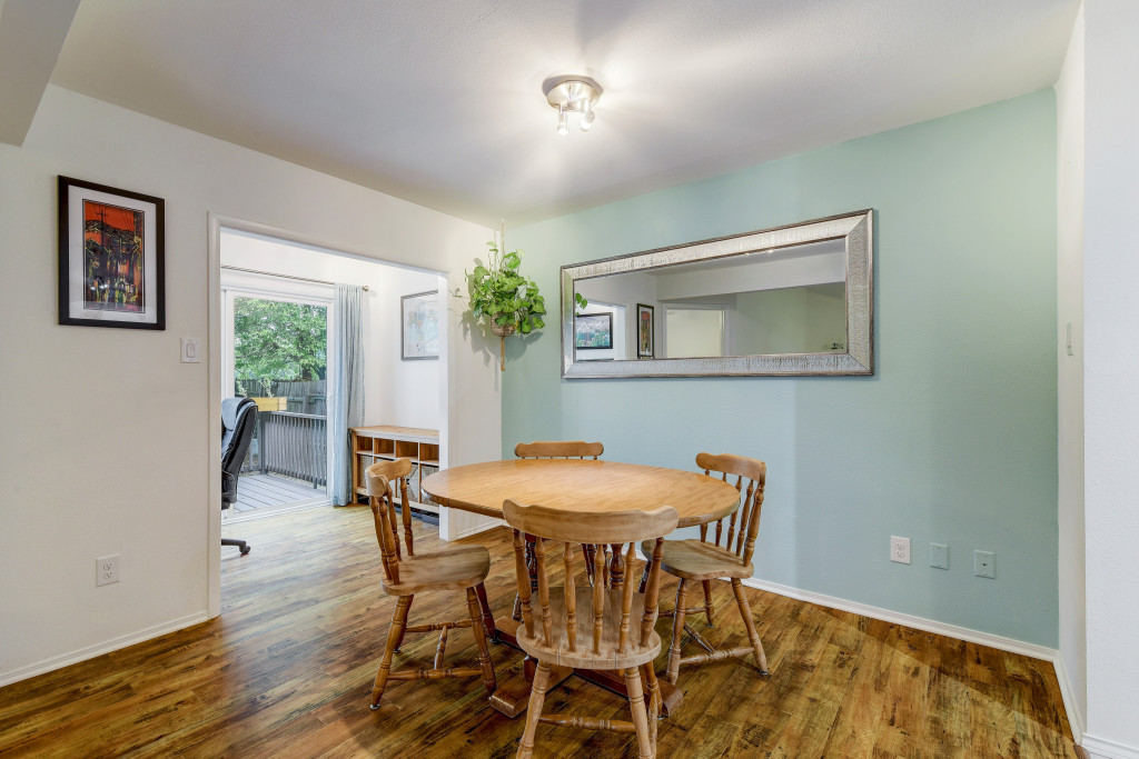 6002 Baton Rouge Drive Austin, TX 78727 - Photo 8 of 20 Interior space featuring wood-finish flooring, a light-colored accent wall, and a ceiling-mounted light fixture