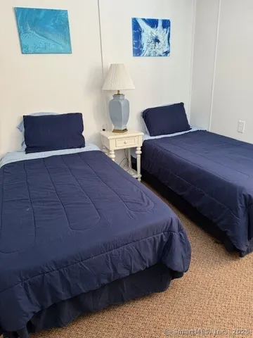 a bedroom with a bed and a night stand