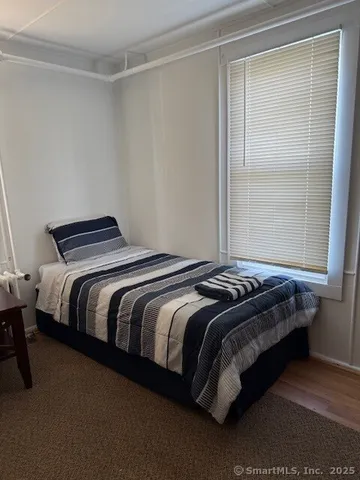 a bedroom with a bed and window