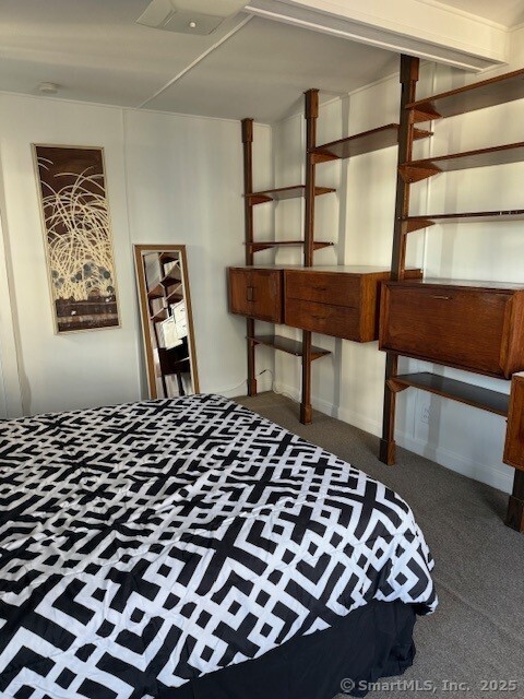 2142 Fairfield Beach Road Fairfield, CT 06824 - Photo 25 of 39 a bedroom with a bed and wooden floor