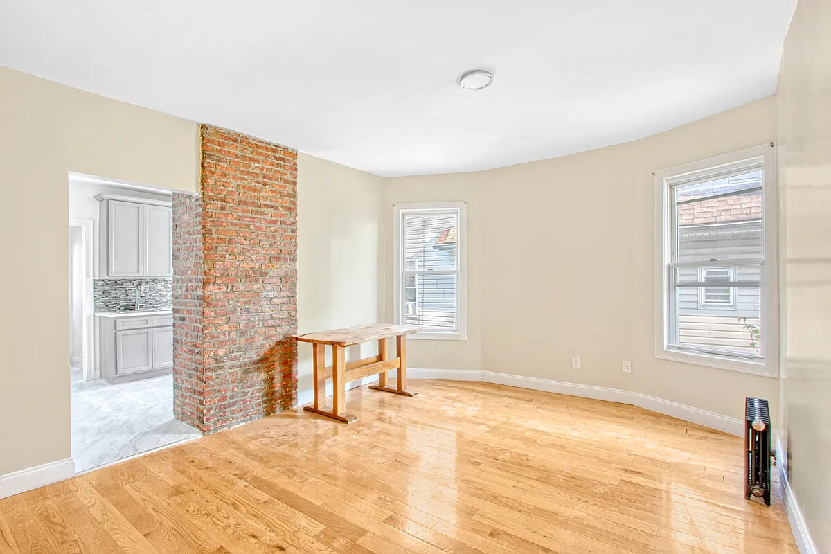 405 East 2nd Street, Unit 2 Brooklyn, NY 11218 - Photo 1 of 16 a bedroom with a bed and wooden floor