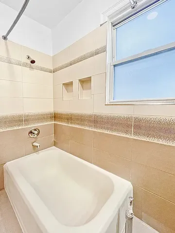 a bathroom with a tub and a shower