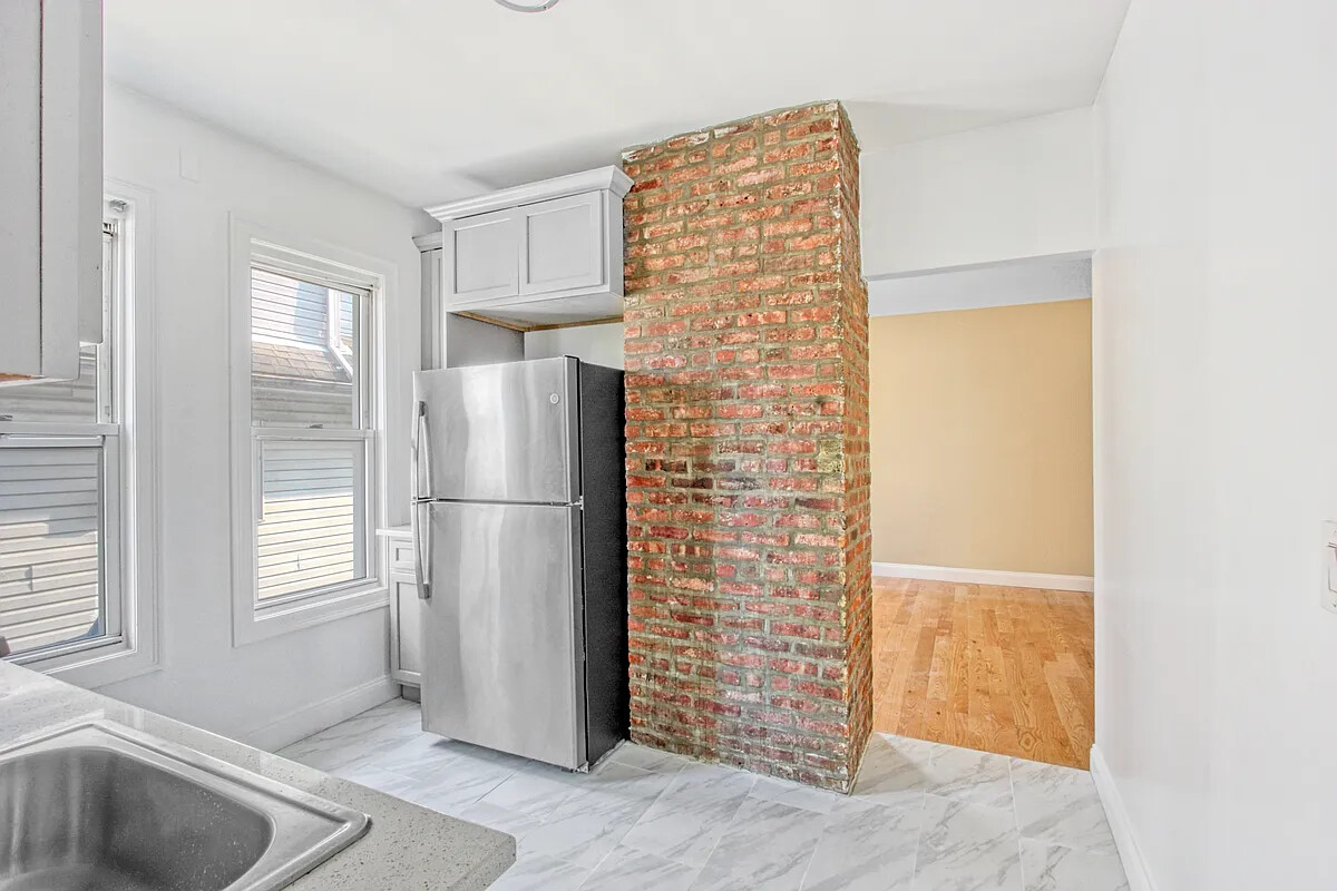 405 East 2nd Street, Unit 2 Brooklyn, NY 11218 - Photo 7 of 16 a kitchen with a refrigerator and a sink
