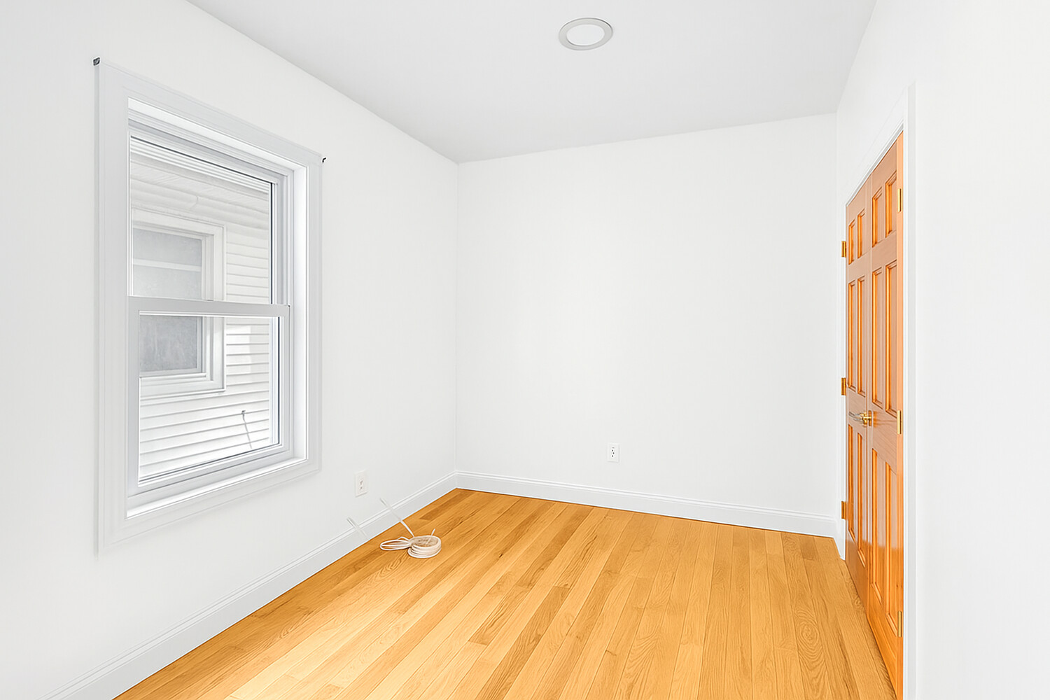 405 East 2nd Street, Unit 2 Brooklyn, NY 11218 - Photo 10 of 16 a view of a room with wooden floor and windows