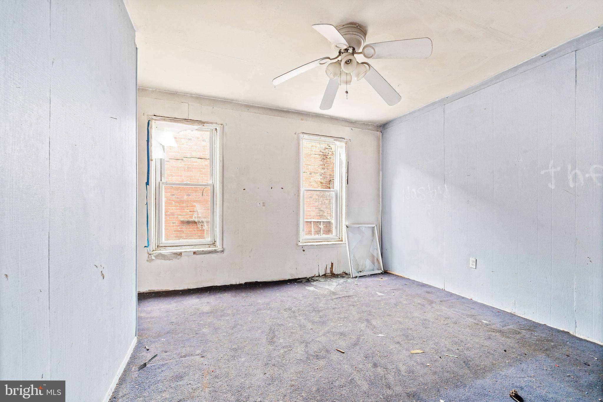 1401 Princess Avenue Camden, NJ 08103 - Photo 15 of 25 an empty room with chandelier fan and windows