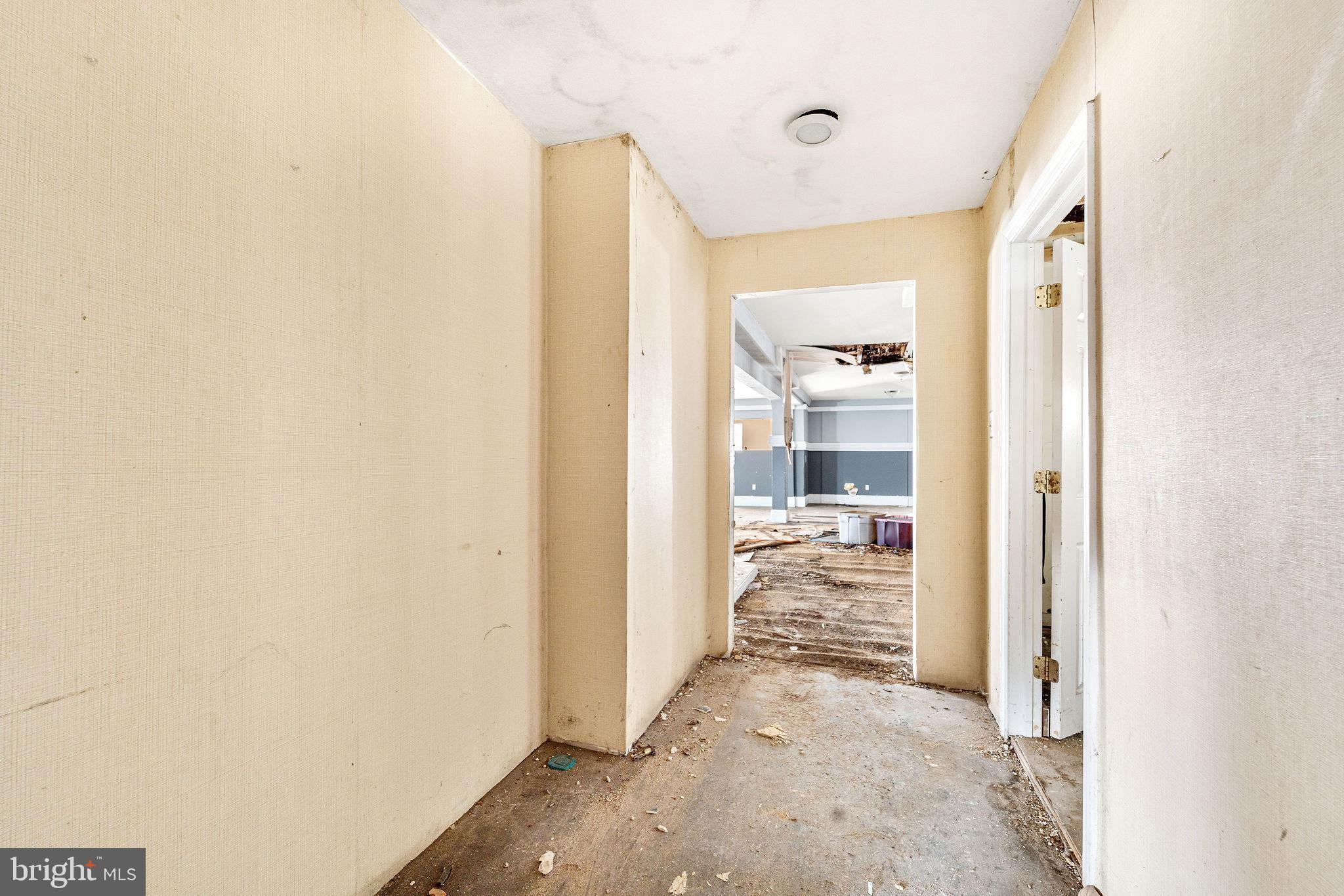 1401 Princess Avenue Camden, NJ 08103 - Photo 10 of 25 a view of a hallway with wooden floor and a bathroom