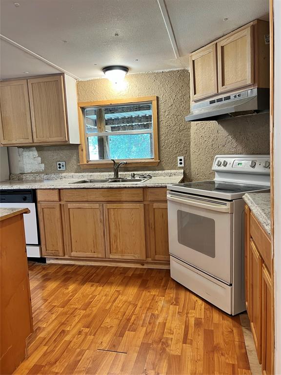2334 San Bar Road, Unit 46 Graford, TX 76449 - Photo 8 of 37 a kitchen with stainless steel appliances granite countertop a stove a sink and a microwave