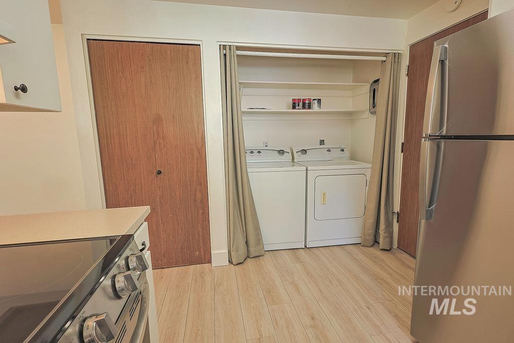 640 Morrison Street Twin Falls, ID 83301 - Photo 12 of 30 Dedicated laundry area with a white washer and dryer, complemented by overhead shelving