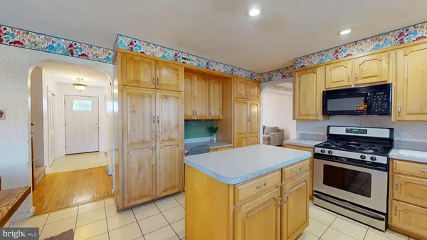 a kitchen that has a stove and a microwave