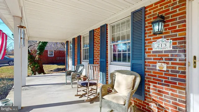 a view of a balcony with chairs and potted plant
