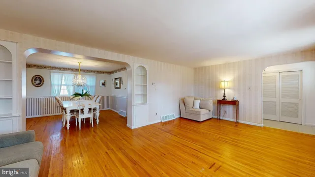 a dining room with furniture and wooden floor