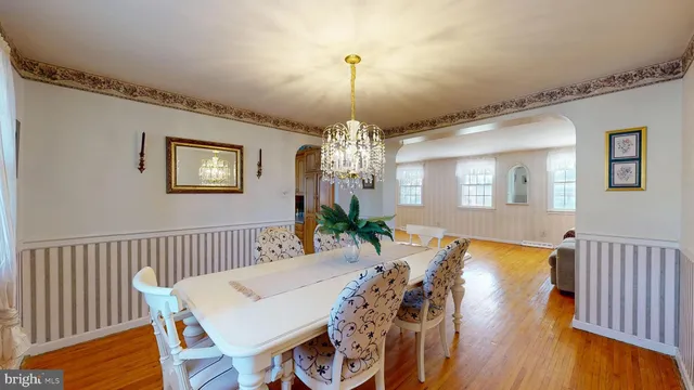 a view of a dining room with furniture wooden floor and chandelier