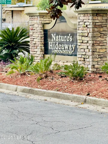 a view of a street with a building and trees